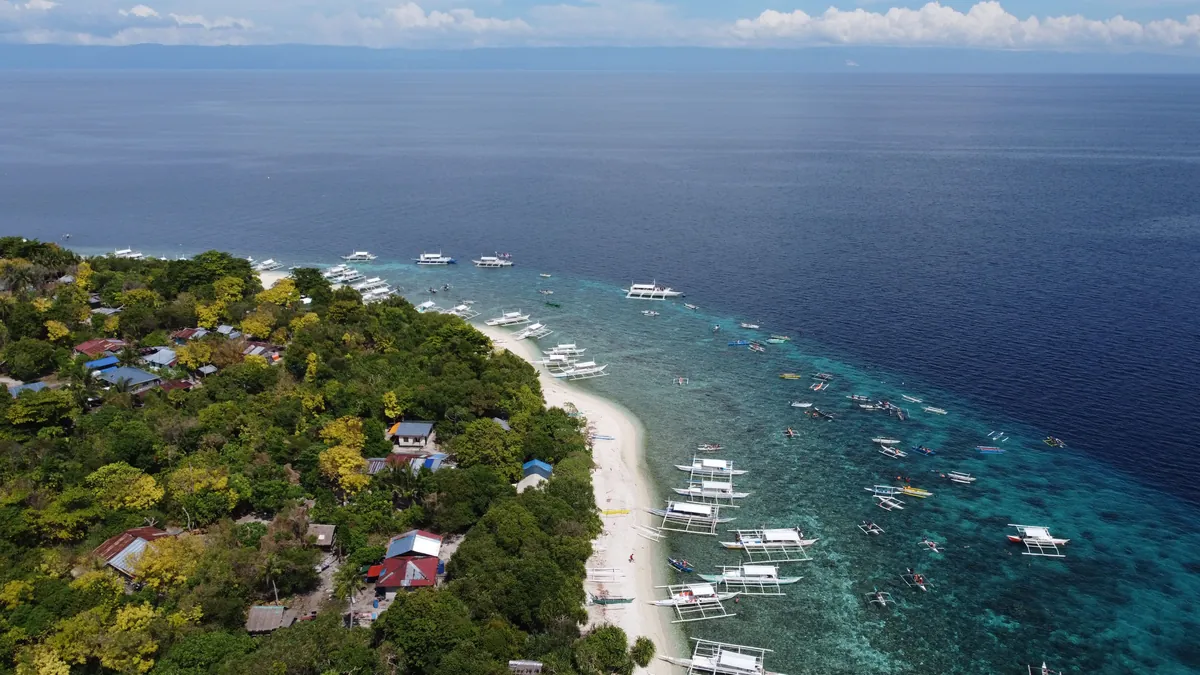 Photo: Bobby Mc Gee Lee (Pexels License) Aerial view of white sand and turquoise shallows on Panglao Island, Bohol